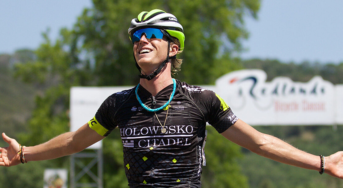 Cyclist celebrating across the finish line.