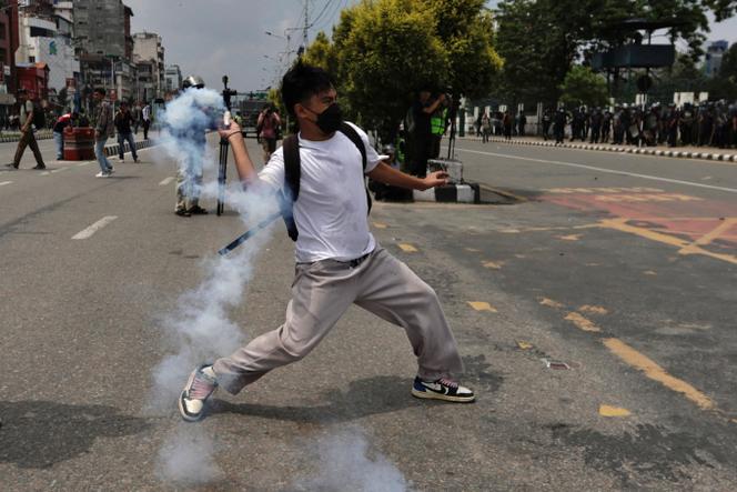 A demonstrator clashes with members of riot police during a protest against corruption and the government’s decision to block several social media platforms, in Kathmandu, Nepal, on September 8, 2025.