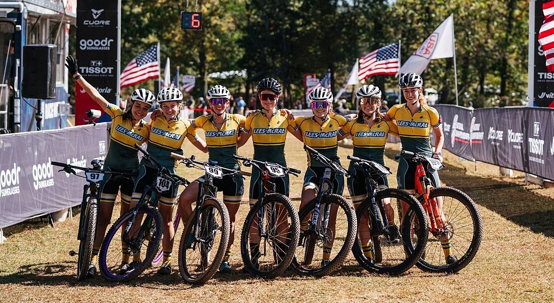 Group of collegiate riders standing at finish line