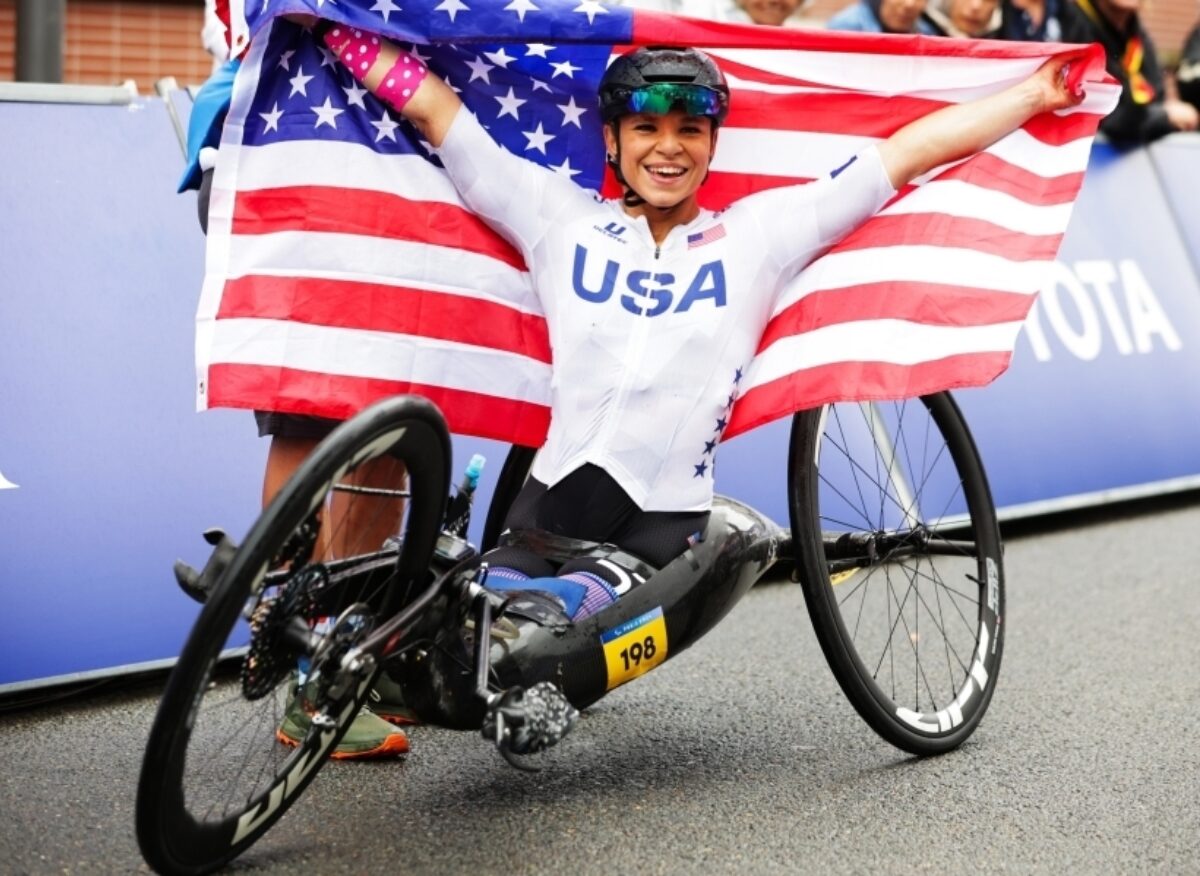 A para-athlete on a tribike holding the American flag. Donate to USA Cycling | Support USA Cycling | USA Cycling Foundation. USA Cycling is a non-profit organization accepting tax-deductible donations.