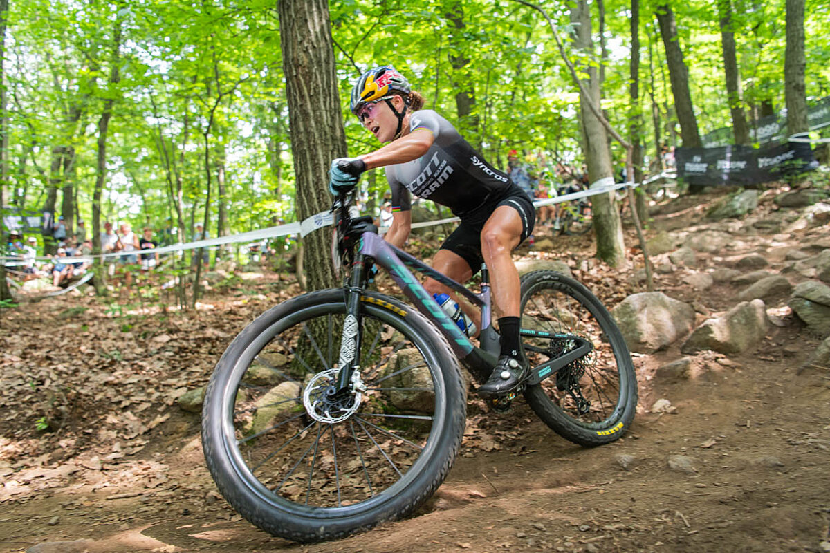 Mountain bike racer taking a corner while racing in the woods