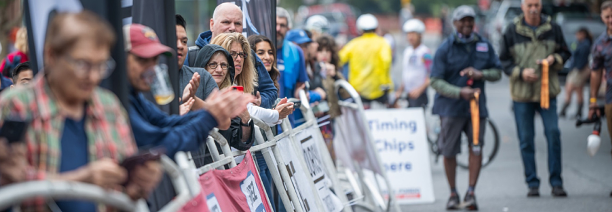 Fans lining road race.