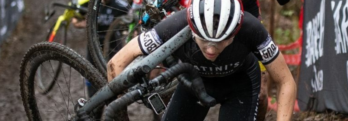 Cyclocross racer carrying his bike.