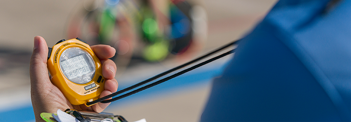 Cycling coach holding a stop watch