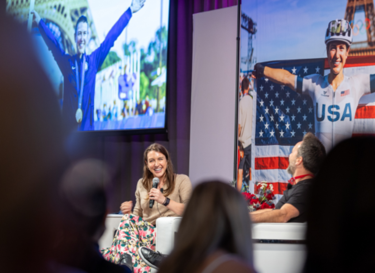Woman smiling on panel at Bicycles and Bluegrass.