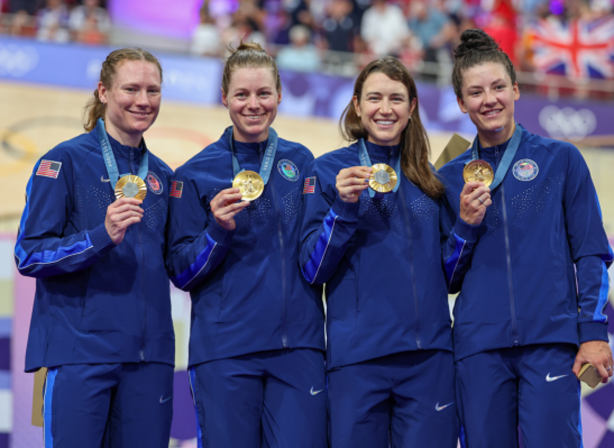 Women's Team Pursuit posing and holding up their medals.
